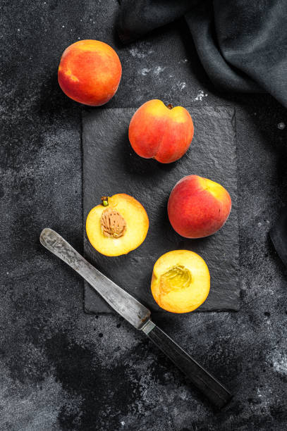istock Organic Peaches fruit on a black stone Board. Black background. Top view 1271012656