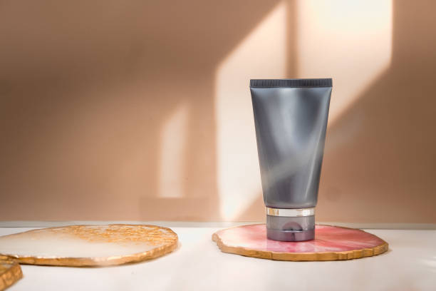istock Grey cosmetic tube on neutral pastel nude background 1271012678