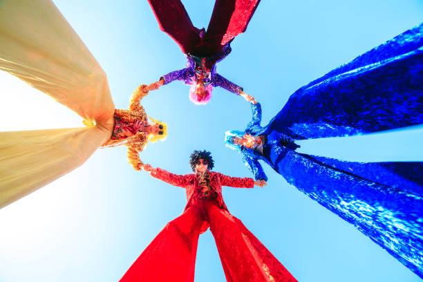 istock Young people on stilts posing against the blue sky. 1271012690