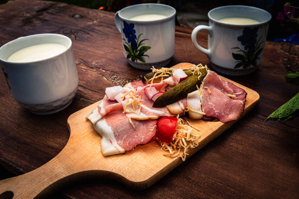 View of traditional Bavaria snacks with milk outdoors near Königsee in the Alps.