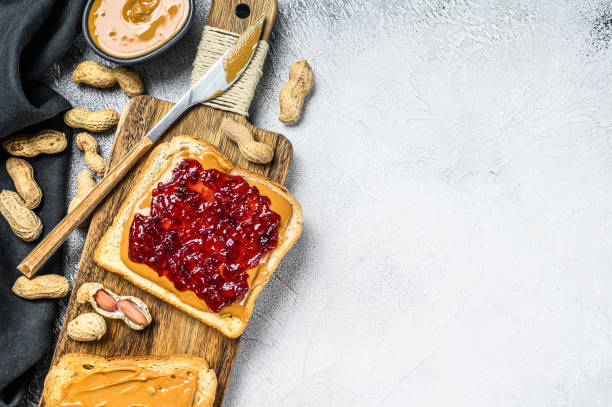 istock Peanut butter sandwich  toast with berry jam.  White background. Top view. Copy space 1271015861