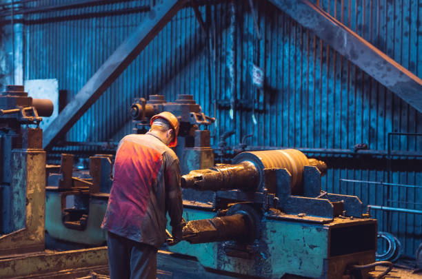 istock Heavy Industry Worker Working Hard on Machine. Rough Industrial Environment 1271016018