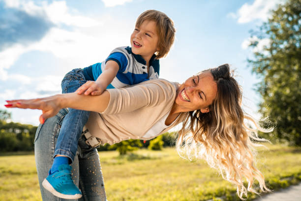 istock Smiling woman is holding her son on back 1271016976