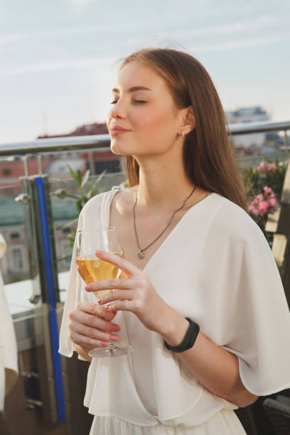 istock Woman drinking wine at rooftop bar 1271017643
