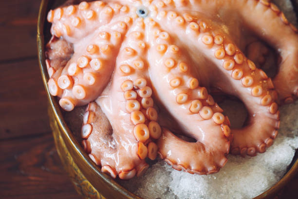 istock Octopus. Seafood in the restaurant. Octopus is prepared in the restaurant on the table. 1271017837
