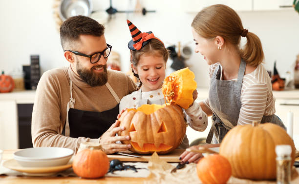 istock Happy family carving jack o lantern 1271018003
