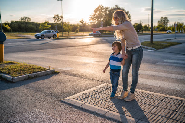 istock Mom and son crossing the road 1271018792