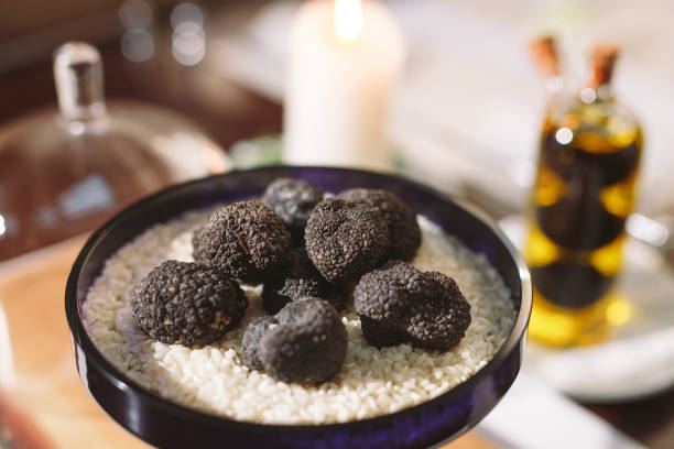 istock Black truffle mushroom on the rice on the table 1271020004