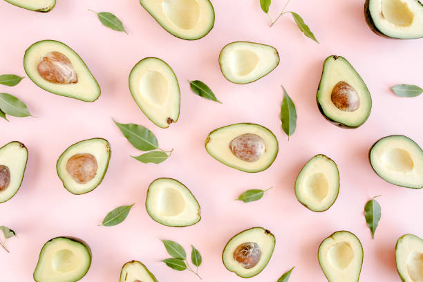 istock Avocado on pink background. Tropical abstract background with avocado. Food concept. flat lay, top view 1271020977