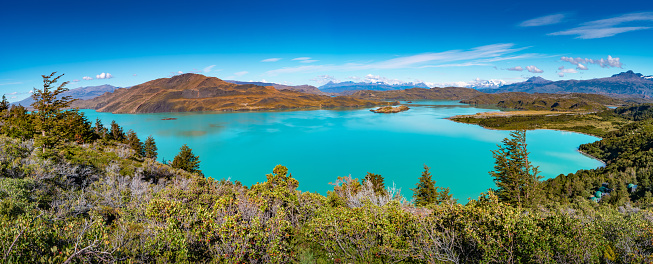 Panoramic view over mountain turquoise lagoon in Torres del Paine National Park at sunny day and blue sky, Patagonia, Chile