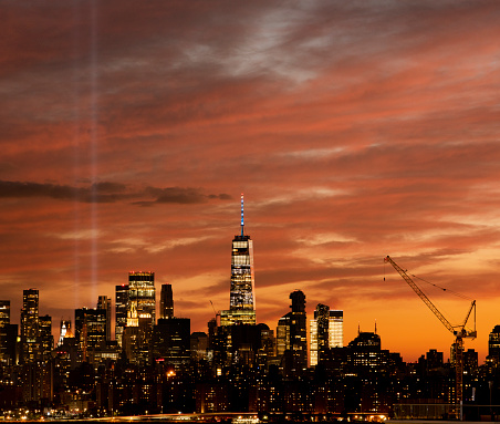 Tribute in light and the One World Trade downtown Manhattan skyline at sunset in New York City.
