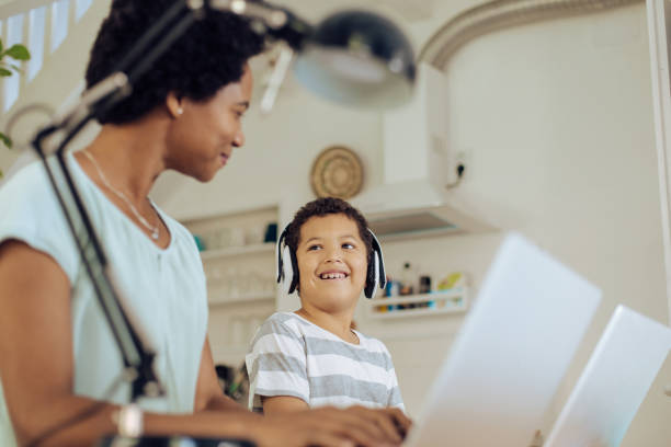 istock Boy having an online class together with his mother freelancing 1271022968