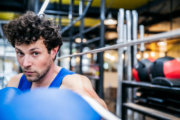 Candid portrait of male boxer challenging camera