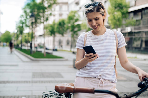 istock Cheerful young blond hair woman using her smart phone 1271031003