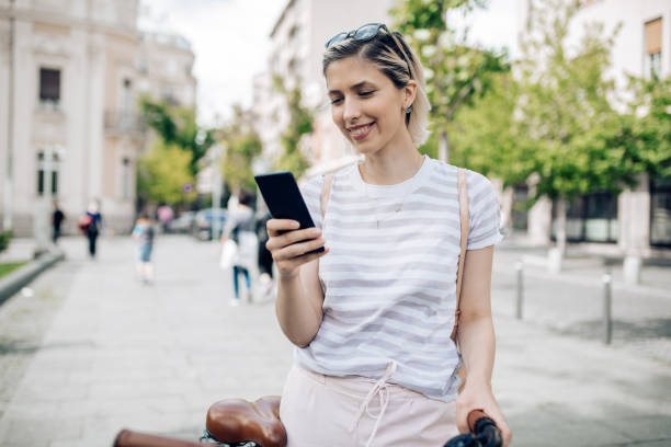 istock Cheerful young blond hair woman using her smart phone 1271031018