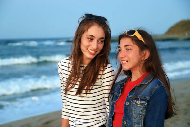 istock Two girls discussing something on th beach 1271031064