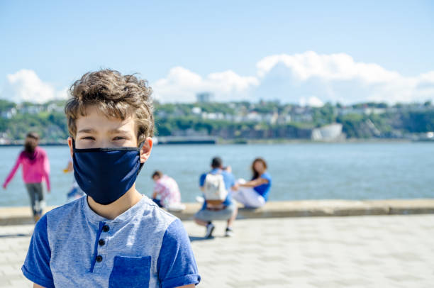 istock Boy wearing mask in city 1271039849