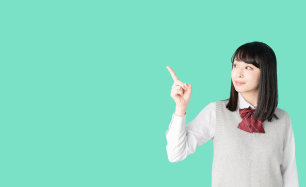 istock Asian school girl pointing at blank space. 1271040591