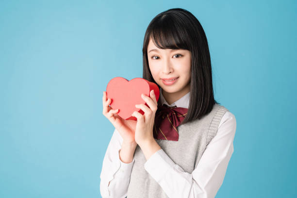 istock Asian school girl holding a heart shape box. 1271040662