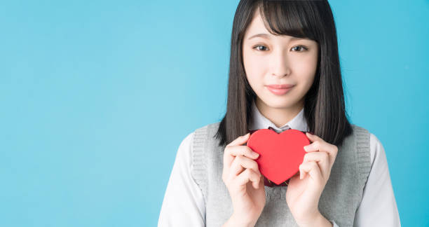 istock Asian school girl holding a heart shape box. 1271040717