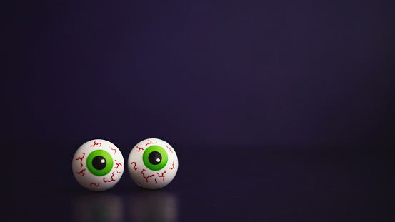 Spooky eyeballs for Halloween on Purple Background