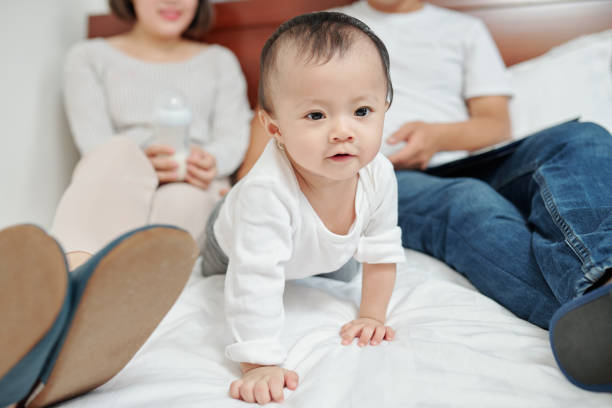 istock Girl crawling on bed 1271047913