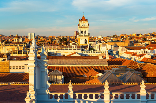 Cityscape of Sucre at sunset with its colonial style rooftops and Cathedral tower, Bolivia.