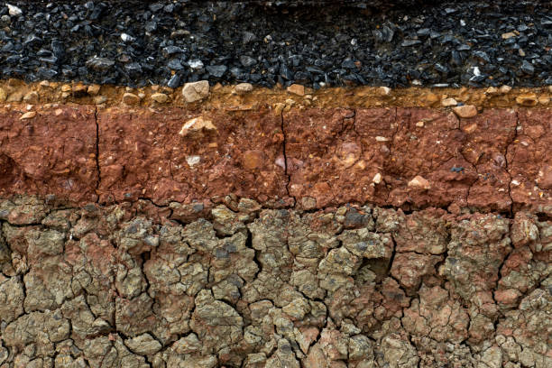 istock The layer of asphalt road with soil and rock. 1271048146