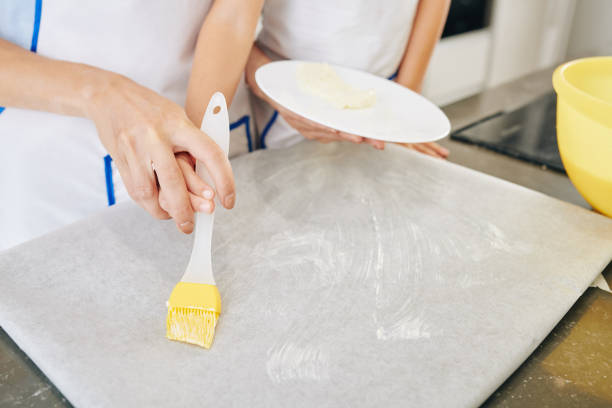 istock Covering parchment paper with soft butter 1271049463