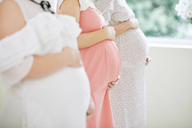 istock Pregnant women touching bellies 1271050027