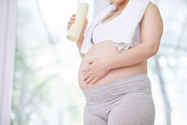 istock Pregnant woman drinking water 1271050041