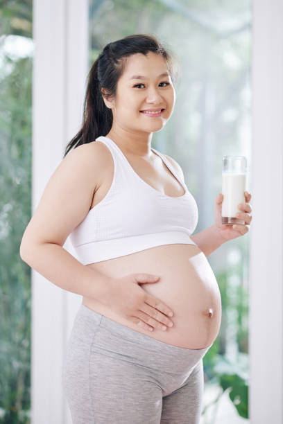 istock Pregnant woman drinking yogurt 1271050045
