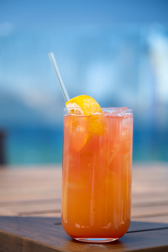 A red and orange swirled cocktail (could be a Mai Tai or a Tequila Sunrise or a Rum Runner or a Fuzzy Navel)