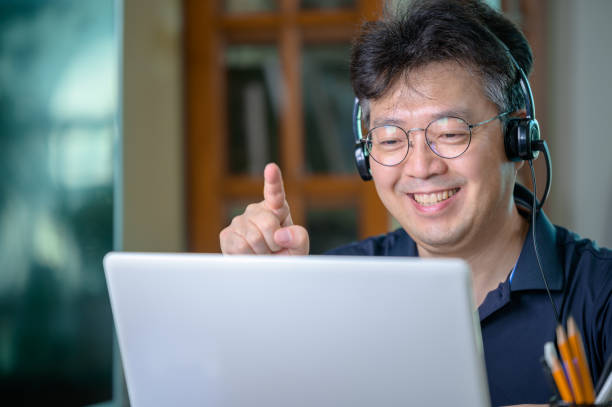 istock Middle-aged Asian man working at home. Telecommuting concept. 1271054260