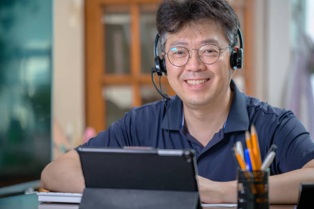 istock Middle-aged Asian man working at home. Telecommuting concept. 1271055346