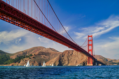 Sailing Under Golden Gate Bridge in Sailboats - Scenic view from a boat while sailing under the Golden Gate Bridge in San Francisco California, USA.