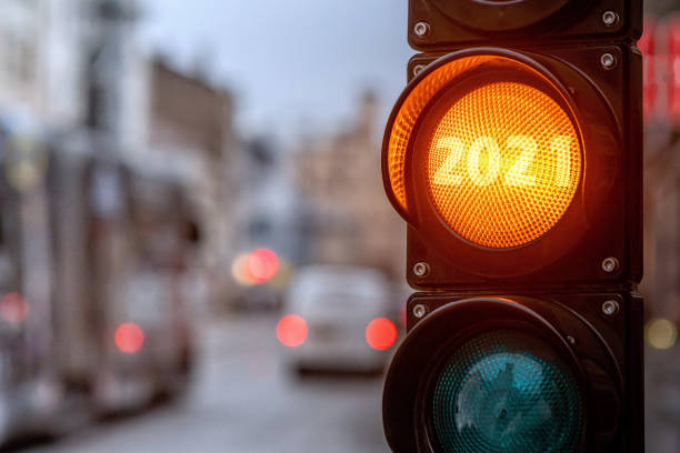 istock A city crossing with a semaphore. Orange light with text 2021 in semaphore. Symbolic New Year approaching concept 1271056014