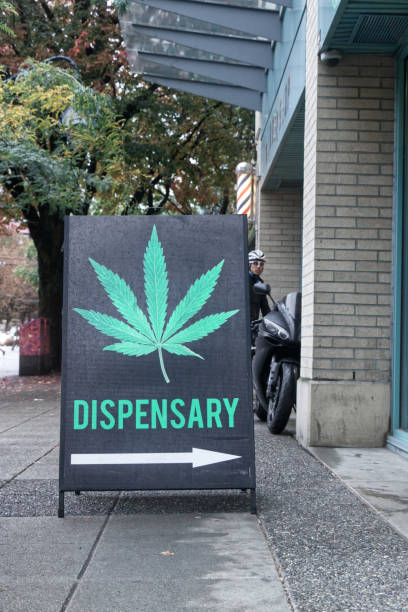 A Black sign "Cannabis dispensary" on Burrard Street Vancouver, Canada - October 7,2019: A Black sign "Cannabis dispensary" in Downtown Vancouver cannabis store photos stock pictures, royalty-free photos & images