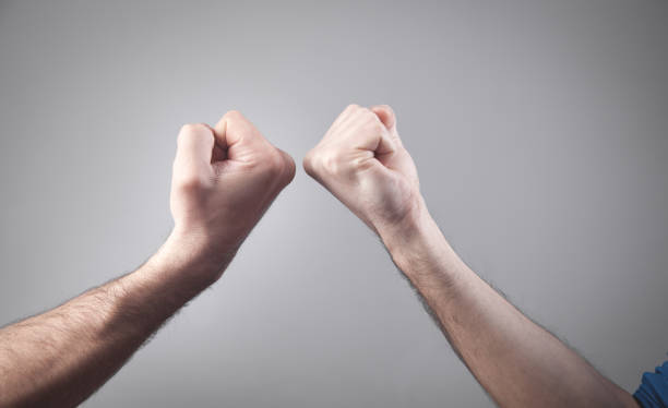 istock Close-up. Two fists hitting each other. Fight 1271059077