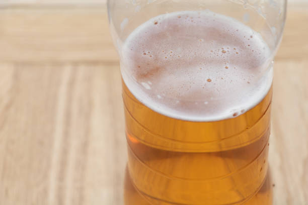 istock Beer in a plastic bottle on wooden background 1271063289
