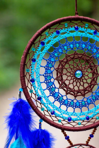istock Handmade dream catcher with feathers threads and beads rope hanging 1271067281