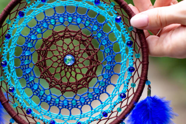 istock Handmade dream catcher with feathers threads and beads rope hanging 1271067293