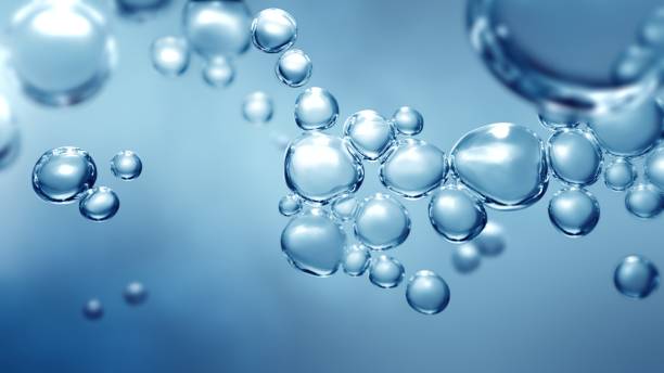 Full Frame Macroscopic Bubbles Beneath Water Bubbling fizz and refreshing beauty care products cleanliness or reviving vitality. Studio shot of transparent effervescent blue gas bubbles levitating in macroscopic view with defocus bokeh blur. sphere photos stock pictures, royalty-free photos & images