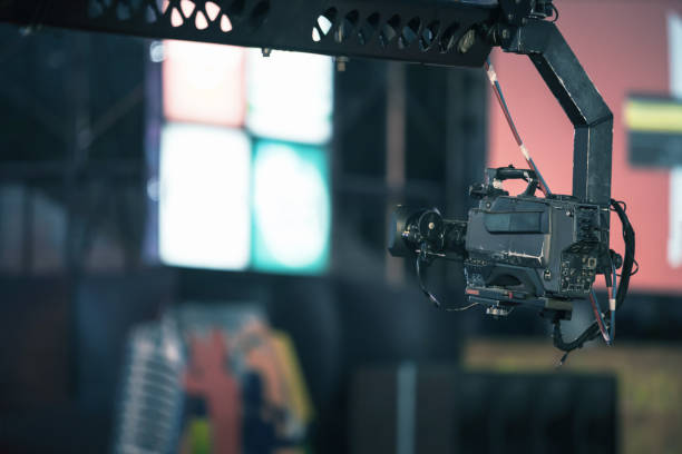 istock Professional digital video camera on crane record live on event broadcasting at night concert outdoors. 1271072242