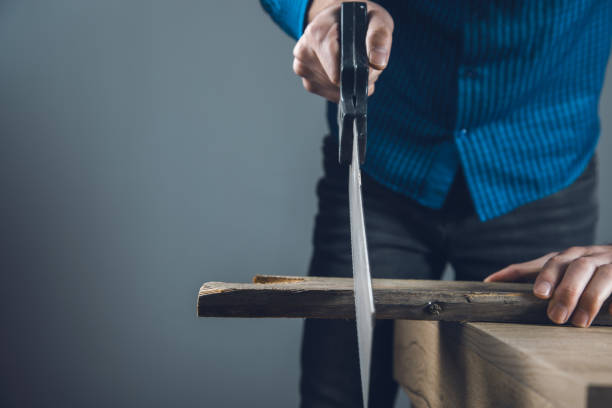 istock cut the wood with a saw 1271073837