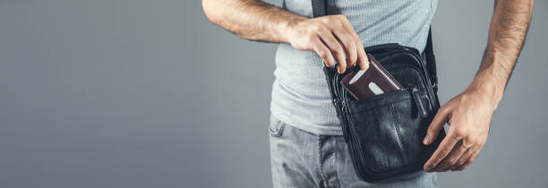 istock man hand wallet and bag 1271073922