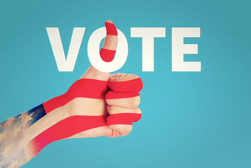 Extruded vote word textured with American flag on white background. Horizontal composition with copy space. Clipping path is included.