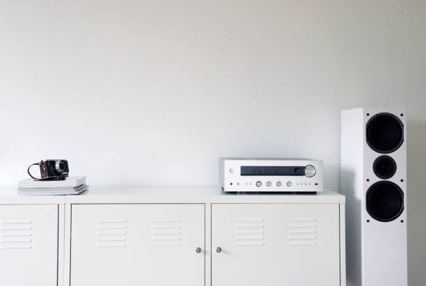 istock Modern audio stereo system with white speakers on bureau in modern interior. 1271078302