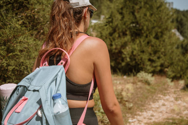istock Rear view of a hiker woman with a backpack 1271083483