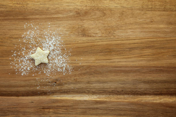 istock 1 star review - pastry star and icing sugar on a wooden surface 1271086399